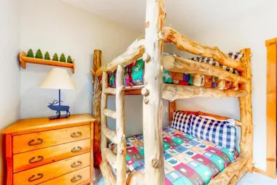 a bedroom with a bed made out of logs at The Seasons Keystone 2 Bedroom In Lakeside Village in Keystone