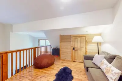 a living room with a couch and a large ottoman at The Seasons Keystone 2 Bedroom In Lakeside Village in Keystone