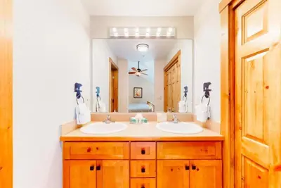 a bathroom with two sinks and a large mirror at The Seasons Keystone 2 Bedroom In Lakeside Village in Keystone