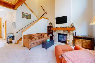 a living room with a couch and a fireplace at The Seasons Keystone 2 Bedroom In Lakeside Village in Keystone