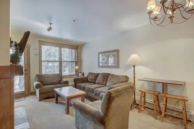 a living room with a couch and a table at 1 Bedroom Condo At The Springs In River Run Village in Keystone