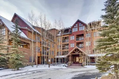 a large building with snow on the ground at 1 Bedroom Condo At The Springs In River Run Village in Keystone