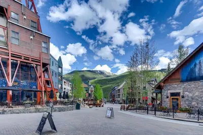 a street in a town with buildings and mountains at 1 Bedroom Condo At The Springs In River Run Village in Keystone