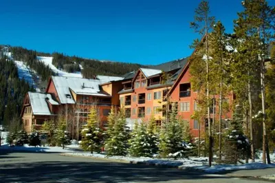 a large building with christmas trees in front of it at 1 Bedroom Condo At The Springs In River Run Village in Keystone