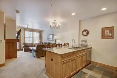 a kitchen with a sink and a living room at 1 Bedroom Condo At The Springs In River Run Village in Keystone