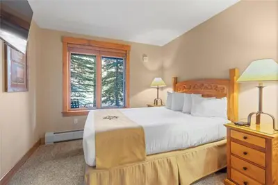 a bedroom with a large bed and a window at 2 Bedroom Condo At The Springs In River Run Village in Dillon