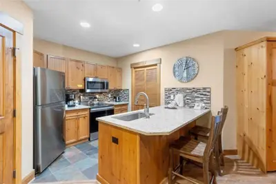 a kitchen with a sink and a refrigerator at 2 Bedroom Condo At The Springs In River Run Village in Dillon