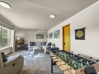 a living room with a large foosball table at 173 Buffalo Drive townhouse in Silverthorne