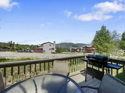 a table and chairs on a balcony with a grill at 173 Buffalo Drive townhouse in Silverthorne