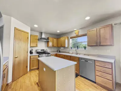 a kitchen with wooden cabinets and a white counter top at 173 Buffalo Drive townhouse in Silverthorne