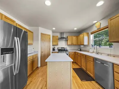 a kitchen with wooden cabinets and a stainless steel refrigerator at 173 Buffalo Drive townhouse in Silverthorne