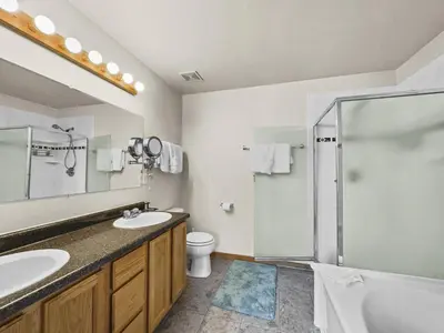a bathroom with two sinks and a shower at 173 Buffalo Drive townhouse in Silverthorne