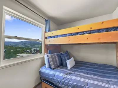a bedroom with a bunk bed and a window at 173 Buffalo Drive townhouse in Silverthorne