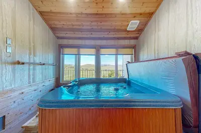 a jacuzzi tub in a room with wooden walls at The Mountainside - Unit B47 in Granby
