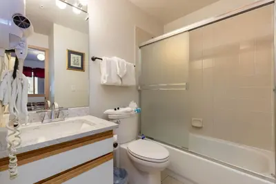 a bathroom with a toilet and a sink and a shower at 113 Cinnamon Ridge condo in Keystone