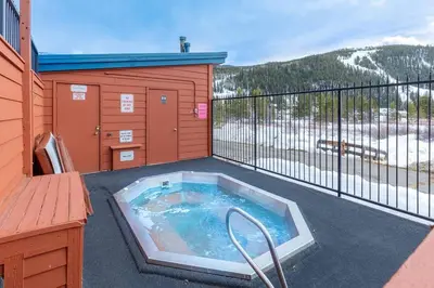a hot tub on the balcony of a house at 113 Cinnamon Ridge condo in Keystone
