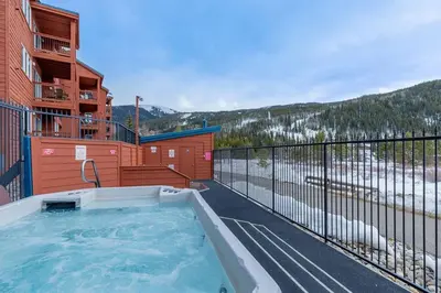 a hot tub on the balcony of a building at 113 Cinnamon Ridge condo in Keystone