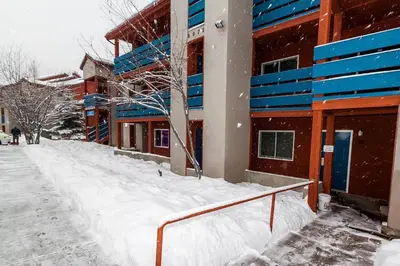 a snow covered sidewalk in front of a building at 113 Cinnamon Ridge condo in Keystone
