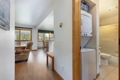 a bathroom with a toilet and a living room at 113 Cinnamon Ridge condo in Keystone