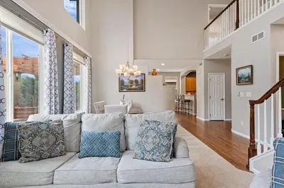 a living room with a couch and a dining room at Large home, Fenced in Back Yard, Cathedral Ceiling in Commerce City