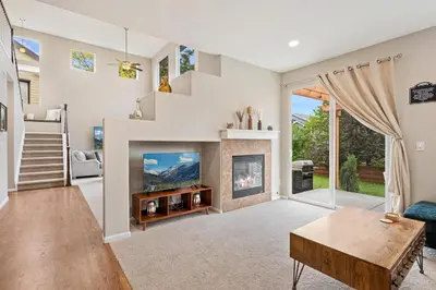 a living room with a fireplace and a tv at Large home, Fenced in Back Yard, Cathedral Ceiling in Commerce City