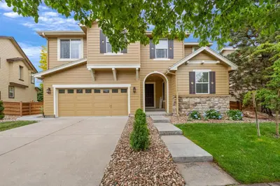 a house with a driveway in front of it at Large home, Fenced in Back Yard, Cathedral Ceiling in Commerce City
