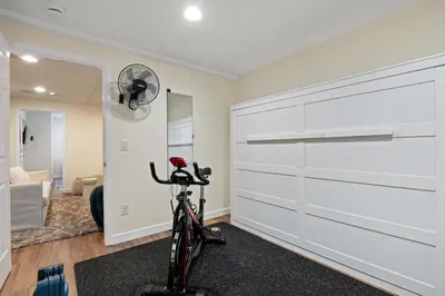 a bike in a room with a garage door at Large home, Fenced in Back Yard, Cathedral Ceiling in Commerce City