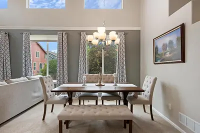 a dining room with a table and chairs and a window at Large home, Fenced in Back Yard, Cathedral Ceiling in Commerce City