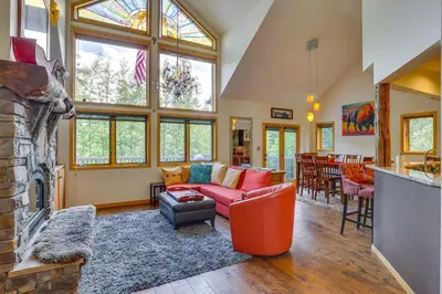 a living room with a couch and a fireplace at Frisco River Gem Close to Slopes, Trails and Main St in Frisco