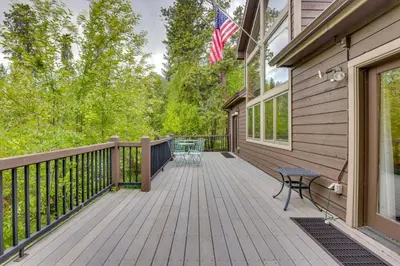 a wooden deck with a bench and an american flag at Frisco River Gem Close to Slopes, Trails and Main St in Frisco