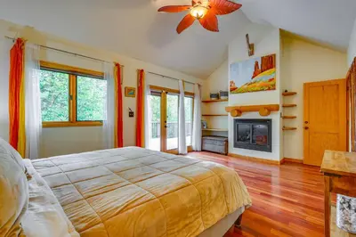 a bedroom with a bed and a fireplace at Frisco River Gem Close to Slopes, Trails and Main St in Frisco
