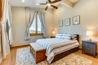 a bedroom with a bed and a ceiling fan at Mountain-View Fraser Condo with Balcony and Hot Tub! in Fraser