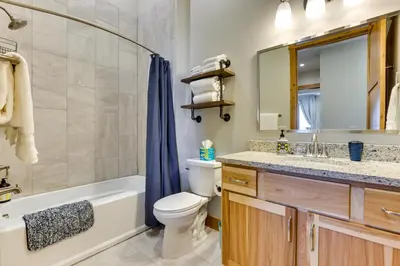 a bathroom with a tub and a toilet and a sink at Mountain-View Fraser Condo with Balcony and Hot Tub! in Fraser