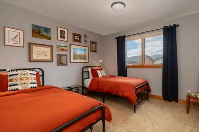 a bedroom with two beds and a window at 2002 Lupine Lane in Tabernash