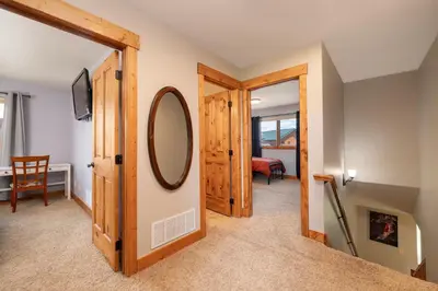 a hallway with a mirror and a room at 2002 Lupine Lane in Tabernash