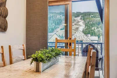 a dining room table with a view of a mountain at 8256 Silver Mill condo in Keystone
