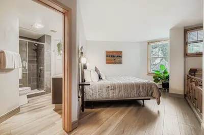a bedroom with a bed and a walk in shower at 8256 Silver Mill condo in Keystone