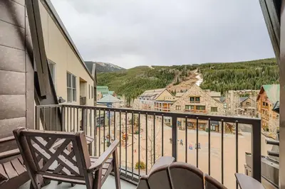 a balcony with chairs and a view of a beach at 8256 Silver Mill condo in Keystone