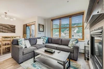 a living room with a couch and a fireplace at 8256 Silver Mill condo in Keystone
