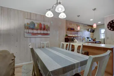 a kitchen and dining room with a table and chairs at 107 Woodbridge condo in Frisco