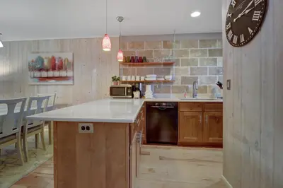 a kitchen with a counter and a clock on the wall at 107 Woodbridge condo in Frisco