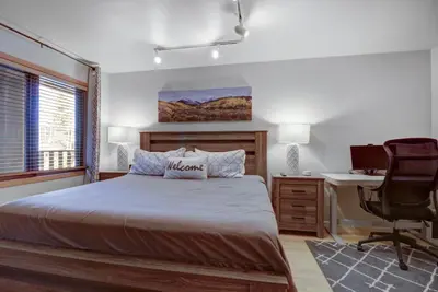 a bedroom with a bed and a desk and a computer at 107 Woodbridge condo in Frisco