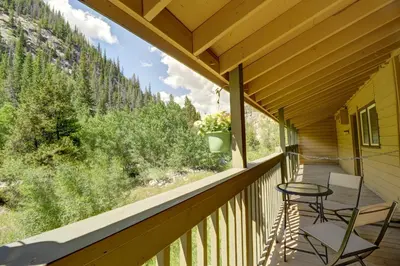 a porch with two chairs and a table on it at 107 Woodbridge condo in Frisco