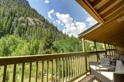 a balcony with chairs and a view of a mountain at 107 Woodbridge condo in Frisco