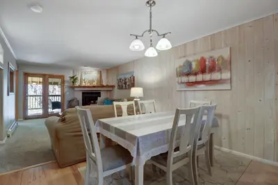 a dining room and living room with a table and chairs at 107 Woodbridge condo in Frisco
