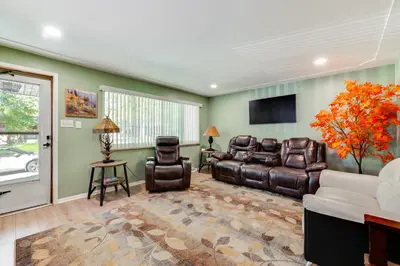 a living room with leather furniture and a flat screen tv at Pet-Friendly Gem with Private Yard in Westminster! in Westminster