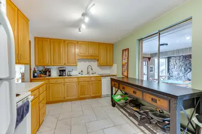 a kitchen with wooden cabinets and a black counter top at Pet-Friendly Gem with Private Yard in Westminster! in Westminster
