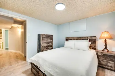 a bedroom with a large bed and a lamp at Pet-Friendly Gem with Private Yard in Westminster! in Westminster