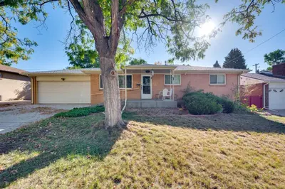a house with a tree in the yard at Pet-Friendly Gem with Private Yard in Westminster! in Westminster