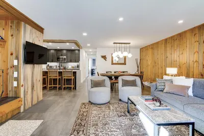 a living room with a couch and a table at Family-Friendly Condo with Mtn Views in Keystone! in Keystone